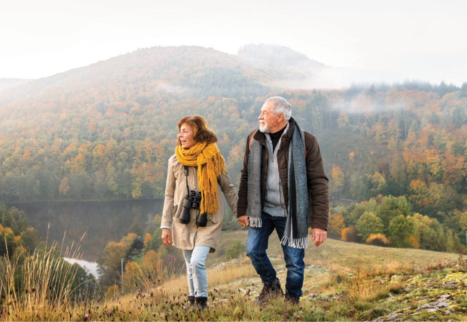 Man and Woman Hiking in the Mountains Overlooking a Lake